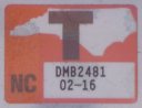 close-up of "T" sticker from the plate shown at left